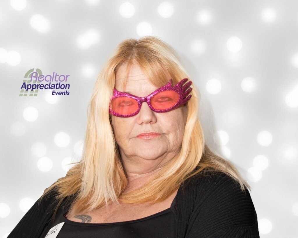 Guest wearing pink glasses in the archived photo booth