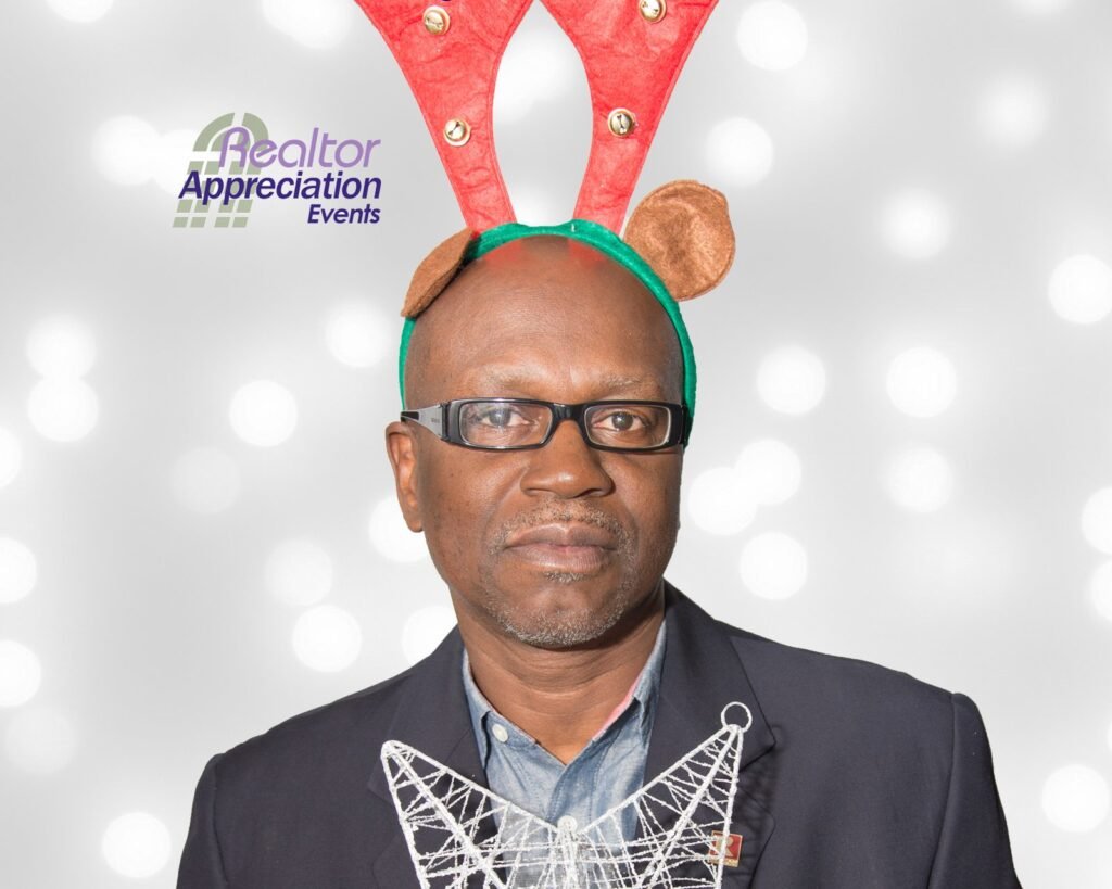 Guest wearing festive antlers and a lei in the archived photo booth