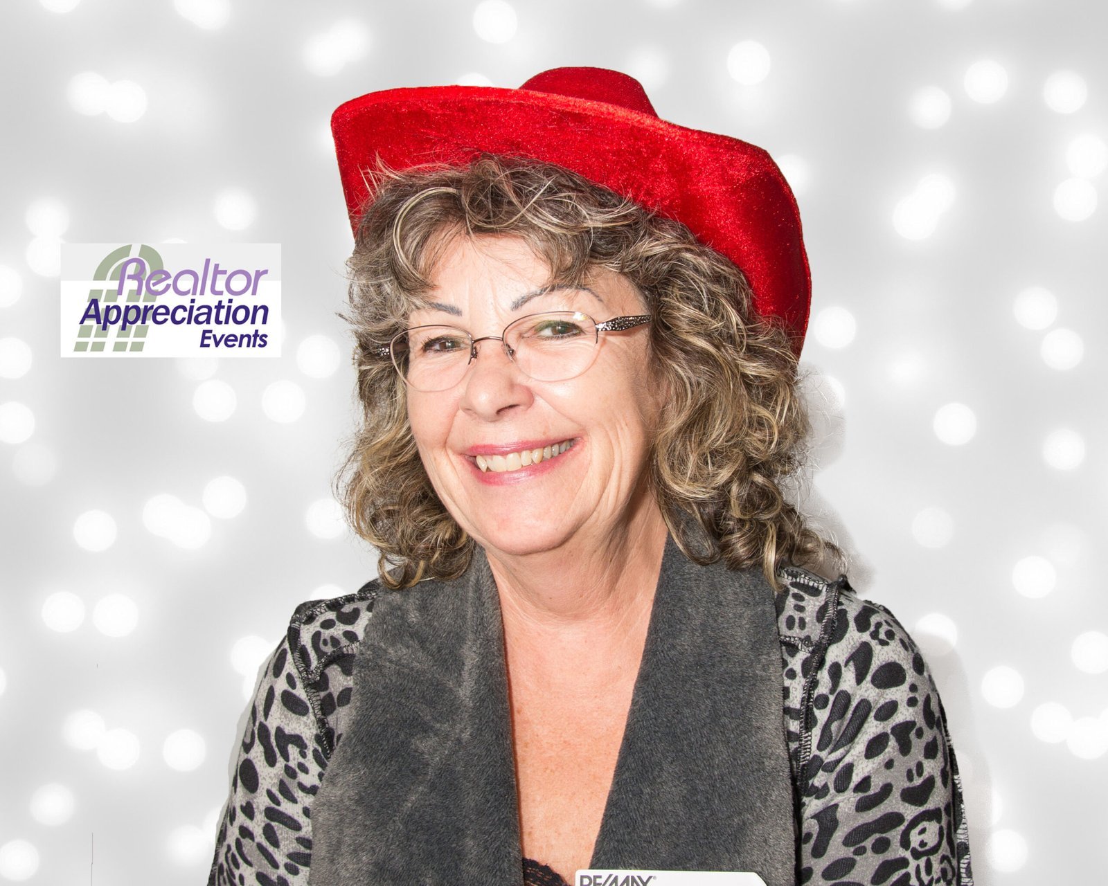 Guest wearing a red hat at a past Realtor Appreciation Events photo booth